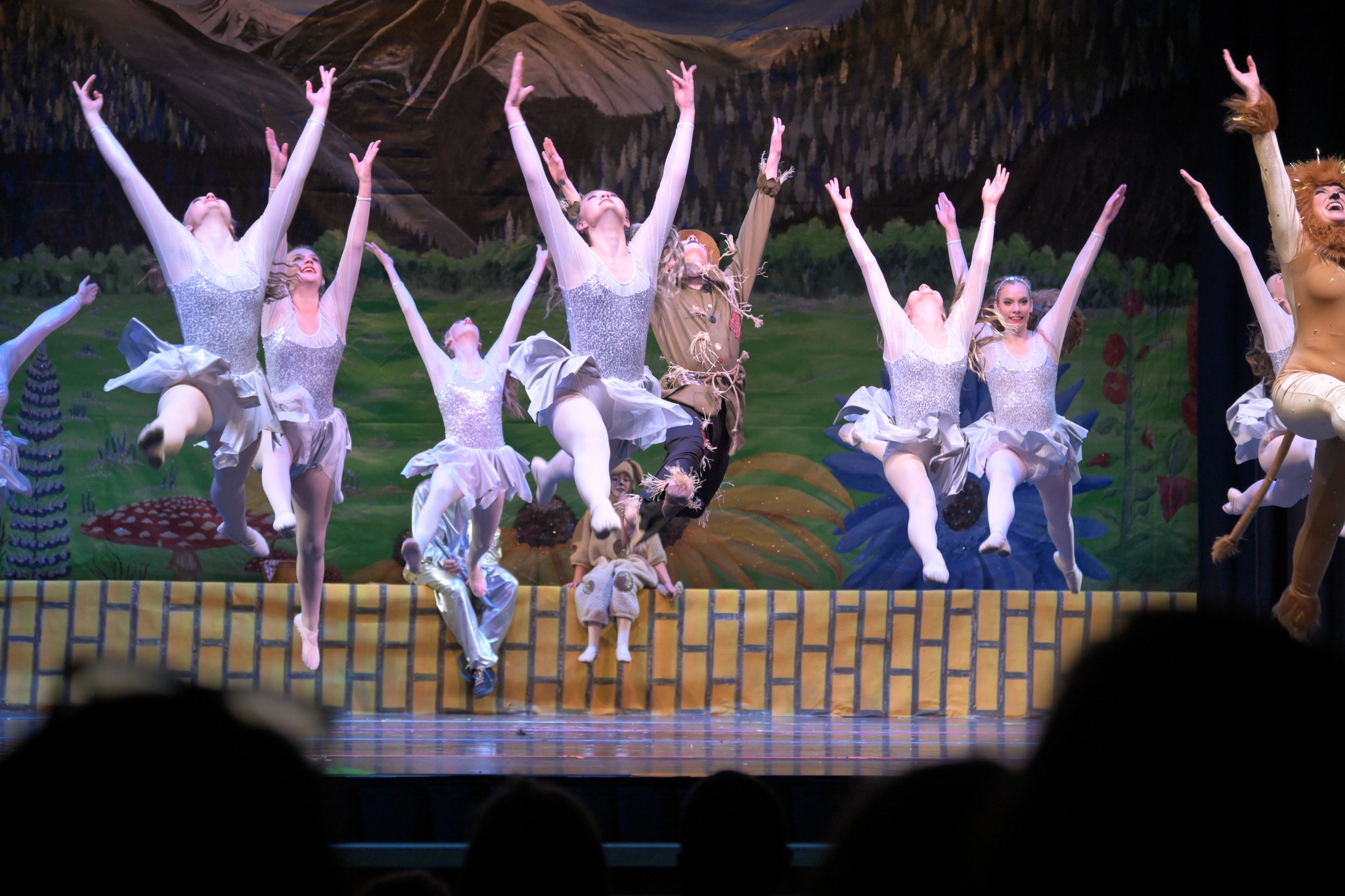 Dancers leaping in silver costumes dance classes Ridgway Colorado youth dancers